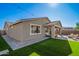 Back exterior view of the house with a grassy yard at 9316 S 39Th Dr, Laveen, AZ 85339