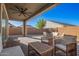 Covered patio with seating area and wooden furniture at 9316 S 39Th Dr, Laveen, AZ 85339