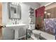 Elegant bathroom featuring a pedestal sink and tub at 9613 W Camino De Oro Dr, Peoria, AZ 85383