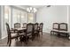 Bright dining room with a wood table and chairs near large windows at 9613 W Camino De Oro Dr, Peoria, AZ 85383