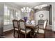 Elegant dining room with dark wood table and chairs at 9613 W Camino De Oro Dr, Peoria, AZ 85383