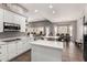 Bright kitchen with white cabinets, an island, and a view to the dining area at 9613 W Camino De Oro Dr, Peoria, AZ 85383