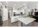 Modern kitchen with white cabinets, a large island, and stainless steel appliances at 9613 W Camino De Oro Dr, Peoria, AZ 85383