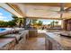 Outdoor kitchen with stone accents and a large grilling area at 9613 W Camino De Oro Dr, Peoria, AZ 85383