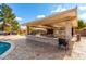 Outdoor kitchen and pool area at 9613 W Camino De Oro Dr, Peoria, AZ 85383