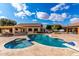 Aerial view of a kidney-shaped pool, spa, and expansive patio at 9613 W Camino De Oro Dr, Peoria, AZ 85383