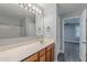 Bathroom boasts vanity with wood cabinets and large mirror at 1033 E Leslie Ave, San Tan Valley, AZ 85140