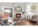 Living room features a fireplace, hardwood floors, and a view to patio at 10401 N 52Nd St # 208, Paradise Valley, AZ 85253