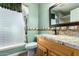 Bathroom with granite countertop, wood cabinets, and a shower at 10611 W Caron Dr, Sun City, AZ 85351