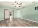 Light and airy bedroom with wood-look floors at 10611 W Caron Dr, Sun City, AZ 85351