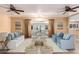 Bright living room with comfy seating and access to a sunroom at 10611 W Caron Dr, Sun City, AZ 85351