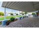Covered patio with brick pavers and lush landscaping at 10611 W Caron Dr, Sun City, AZ 85351