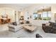 Spacious living room with curved sofa and large windows at 10760 E Caribbean Ln, Scottsdale, AZ 85255