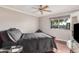 Well-lit bedroom with hardwood floors and ceiling fan at 11122 W Desert Butte Dr, Sun City, AZ 85351