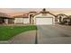 House exterior showcasing a two-car garage and well-maintained landscaping at 12558 W Holly St, Avondale, AZ 85392