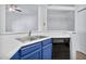 Kitchen with blue cabinets, stainless steel sink, and dishwasher at 1331 W Baseline Rd # 316, Mesa, AZ 85202