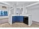 Open kitchen with blue cabinets, a breakfast bar, and views to the living room at 1331 W Baseline Rd # 316, Mesa, AZ 85202