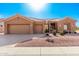 Single-story home with a two-car garage and desert landscaping at 14233 W Via Montoya --, Sun City West, AZ 85375