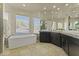 Spa-like bathroom with double vanities, soaking tub, and walk-in shower at 14425 S Canyon Dr, Phoenix, AZ 85048