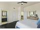 Spacious bedroom with ensuite bathroom and dark wood floors at 14425 S Canyon Dr, Phoenix, AZ 85048