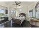 Bright bedroom with dark wood furniture, private balcony, and built-in desk at 14425 S Canyon Dr, Phoenix, AZ 85048