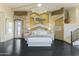 Spacious primary bedroom with dark hardwood floors and a king-size bed at 14425 S Canyon Dr, Phoenix, AZ 85048