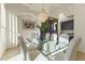 Elegant dining room features a glass table and crystal chandelier at 14425 S Canyon Dr, Phoenix, AZ 85048