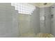 Walk-in shower with mosaic tile and glass block accents at 14425 S Canyon Dr, Phoenix, AZ 85048