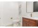 Modern bathroom with white toilet and wood vanity at 14525 W Andrea Dr, Surprise, AZ 85387