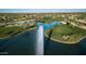 Aerial view of a golf course with a lake and fountain at 15113 W Cactus Ridge Way, Surprise, AZ 85374
