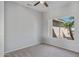 Spacious bedroom with neutral walls, carpet flooring, and a large window at 15113 W Cactus Ridge Way, Surprise, AZ 85374