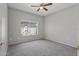 Spacious bedroom with ceiling fan and carpeted floor at 15113 W Cactus Ridge Way, Surprise, AZ 85374