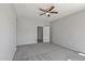 Spacious bedroom with ceiling fan and access to bathroom at 15113 W Cactus Ridge Way, Surprise, AZ 85374
