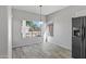 Simple dining area with wood-look floors and natural light at 15113 W Cactus Ridge Way, Surprise, AZ 85374