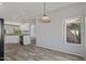 Bright dining area with wood-look floors and view to backyard at 15113 W Cactus Ridge Way, Surprise, AZ 85374