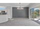 Bright dining room featuring a chandelier and access to the backyard at 15113 W Cactus Ridge Way, Surprise, AZ 85374