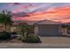 One-story house with terracotta tile roof at sunset at 15113 W Cactus Ridge Way, Surprise, AZ 85374