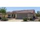 Tan house with tile roof, garage, and mature landscaping at 15113 W Cactus Ridge Way, Surprise, AZ 85374