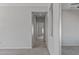 Clean hallway with tile flooring and access to bedrooms at 15113 W Cactus Ridge Way, Surprise, AZ 85374