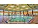 Indoor swimming pool with large windows and high ceilings at 15113 W Cactus Ridge Way, Surprise, AZ 85374