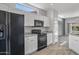 Modern kitchen with black appliances and white cabinets at 15113 W Cactus Ridge Way, Surprise, AZ 85374