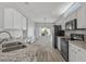 Updated kitchen boasts granite counters, white cabinets, and black appliances at 15113 W Cactus Ridge Way, Surprise, AZ 85374