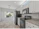Bright kitchen with granite countertops, white cabinets, and black appliances at 15113 W Cactus Ridge Way, Surprise, AZ 85374