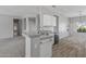 Modern kitchen features granite countertops, white cabinets, and stainless steel appliances at 15113 W Cactus Ridge Way, Surprise, AZ 85374