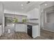 Spacious kitchen with granite countertops, white cabinets, and a view to backyard at 15113 W Cactus Ridge Way, Surprise, AZ 85374