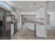 Open kitchen with granite countertops and white cabinets at 15113 W Cactus Ridge Way, Surprise, AZ 85374