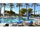 Community lap pool with palm trees and lounge chairs at 15113 W Cactus Ridge Way, Surprise, AZ 85374