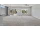 Spacious living room with carpet flooring and large windows showing the backyard at 15113 W Cactus Ridge Way, Surprise, AZ 85374
