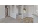 Open living area with neutral walls, tile and carpet flooring, and a view of the backyard at 15113 W Cactus Ridge Way, Surprise, AZ 85374