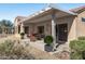 Covered patio with seating area, offering a relaxing outdoor space at 15113 W Cactus Ridge Way, Surprise, AZ 85374